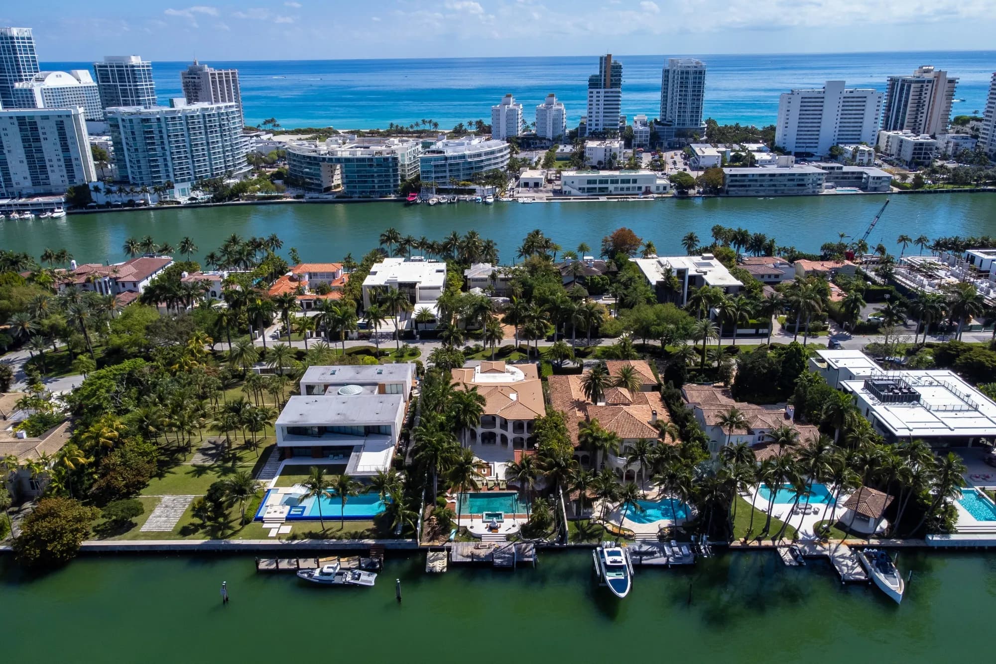 An aerial view of waterfront homes and high-rise condominiums along a coastal waterway in Florida.