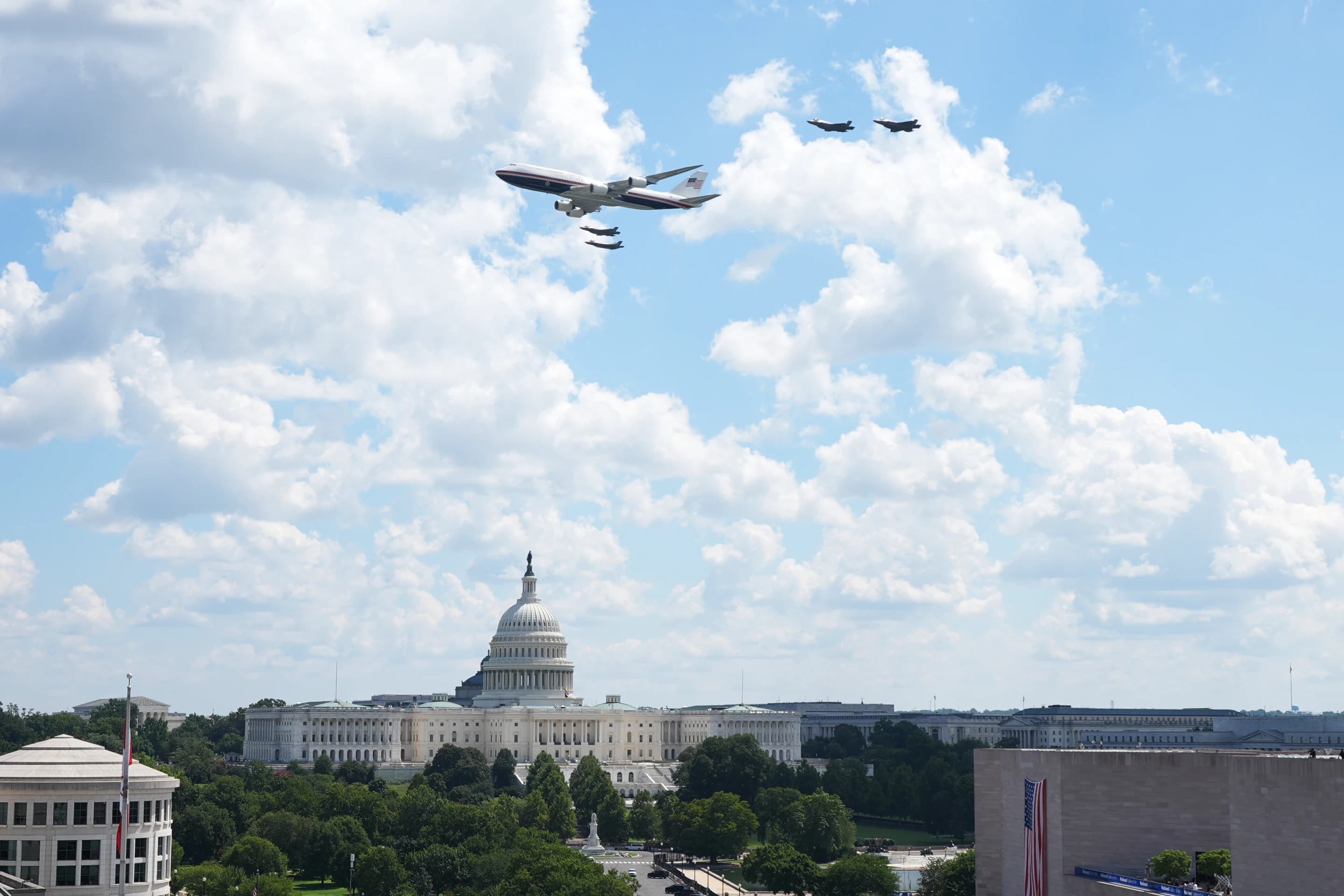 Air Force One and fighter jet escorts fly over the U.S. Capitol during Freedom 250 festivities in Washington.