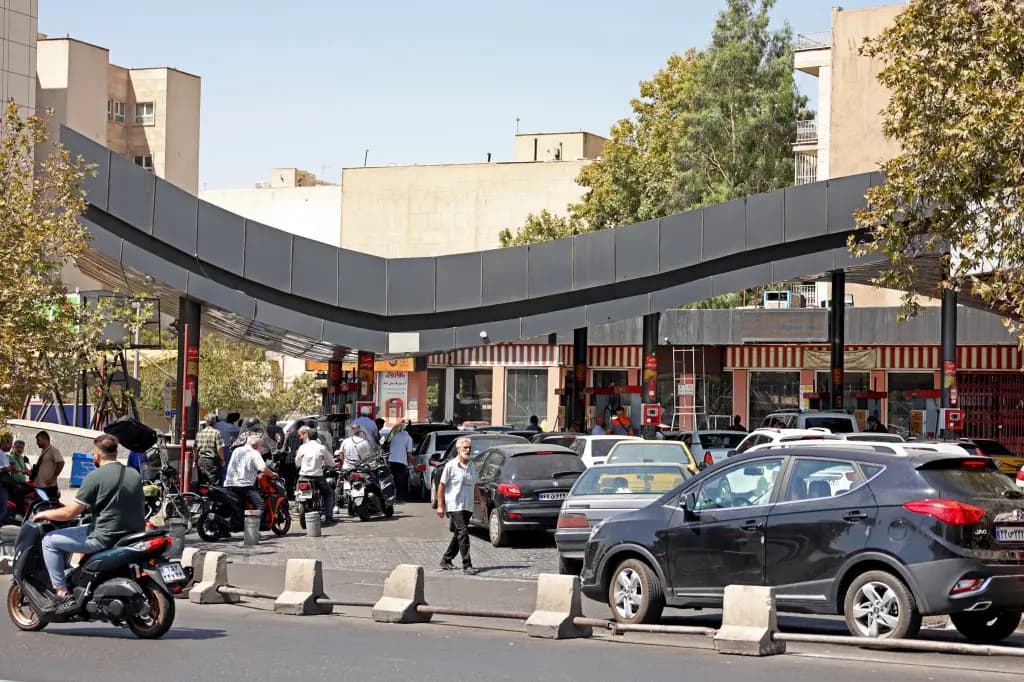 Cars and motorbikes line up at a gas station in Tehran amid fuel shortages.