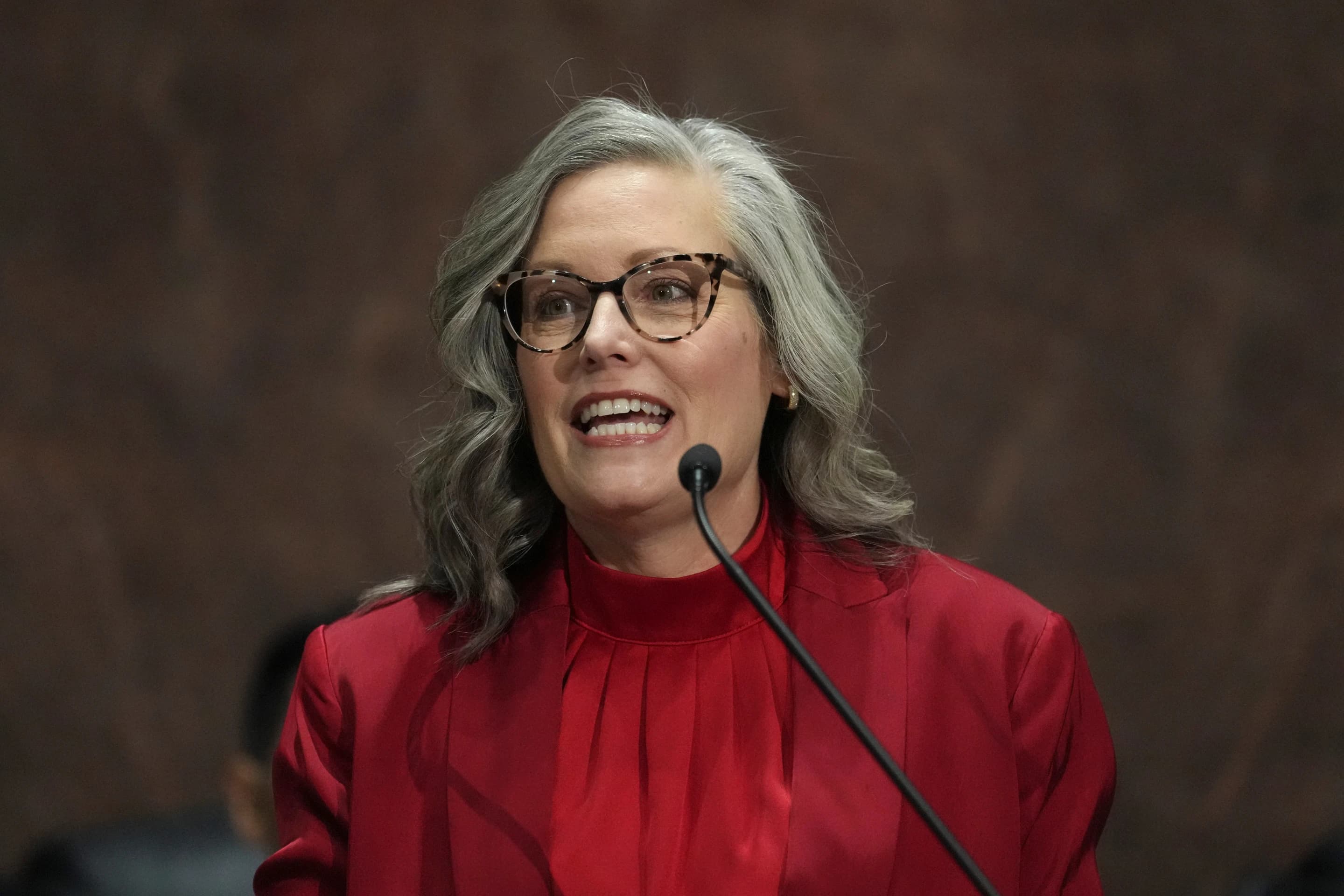 Arizona Governor Katie Hobbs speaking into a microphone during a public appearance.