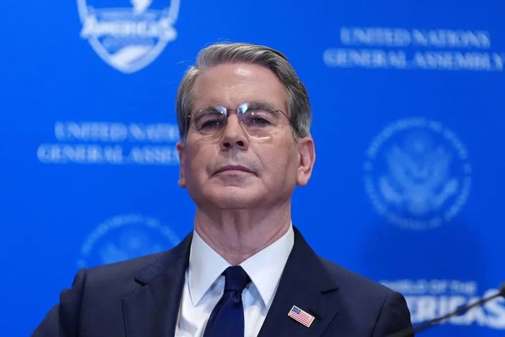 Treasury Secretary Scott Bessent standing at a podium in front of a blue backdrop reading United Nations General Assembly