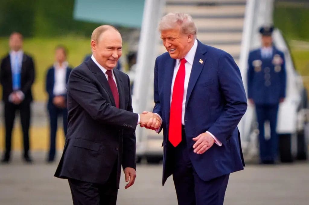President Trump and Russian President Vladimir Putin shaking hands on an airport tarmac near the steps of Air Force One