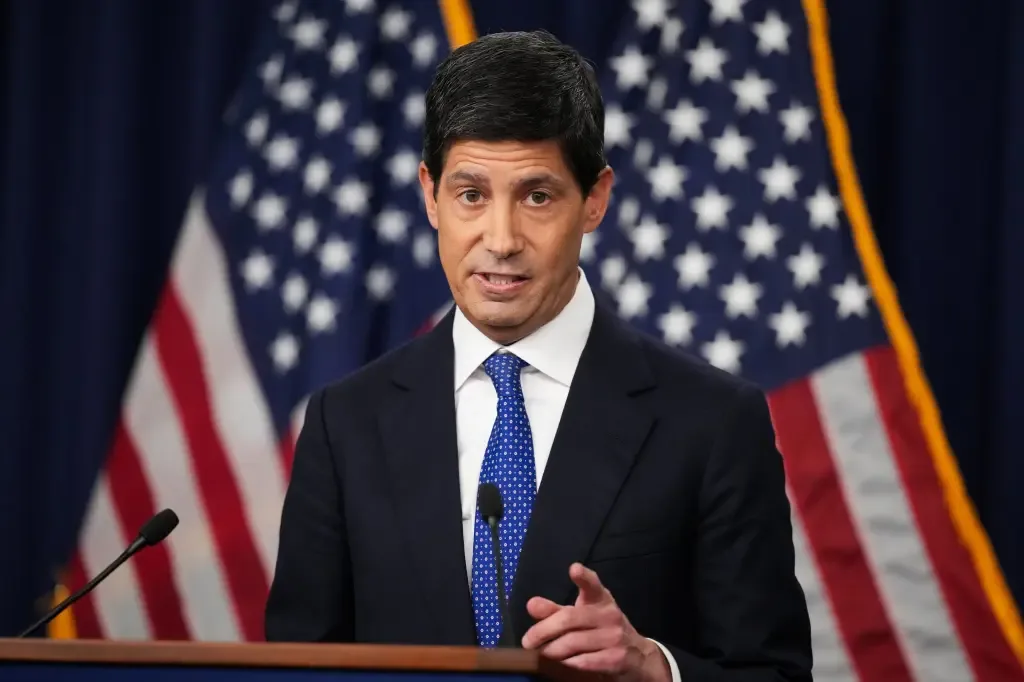A government official speaking at a podium in front of American flags
