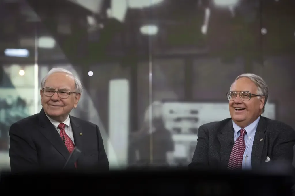 Warren Buffett and Howard Buffett sitting together and smiling during a television interview