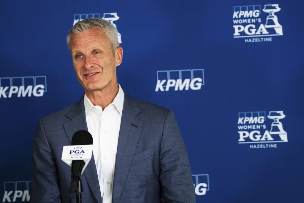 Tim Walsh, KPMG's U.S. chair and chief executive, speaking at a podium in front of a blue KPMG backdrop