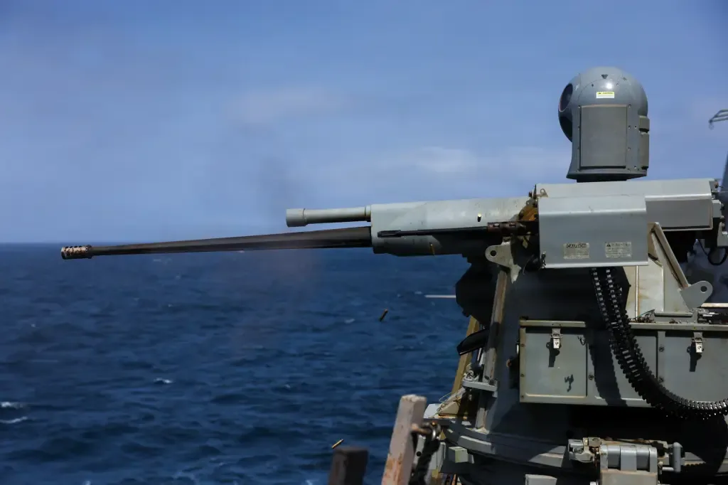 A weapon system aboard a U.S. Navy ship firing over open water