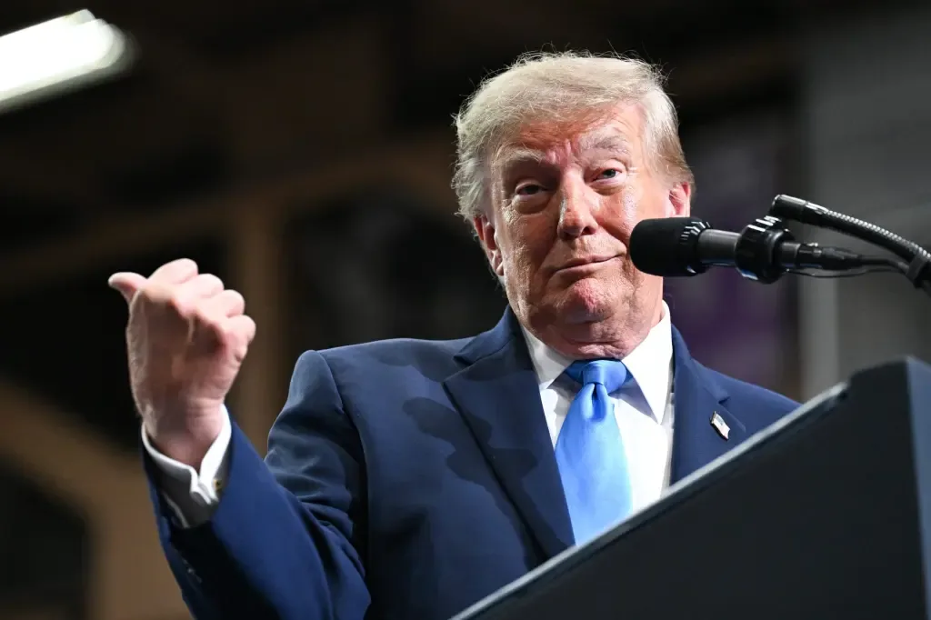President Donald Trump speaking and gesturing at a podium