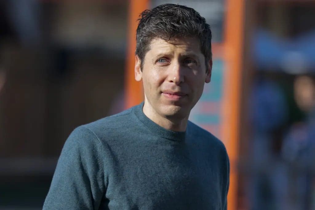 Sam Altman, OpenAI's chief executive, looking to the side outdoors in natural light, wearing a gray sweater