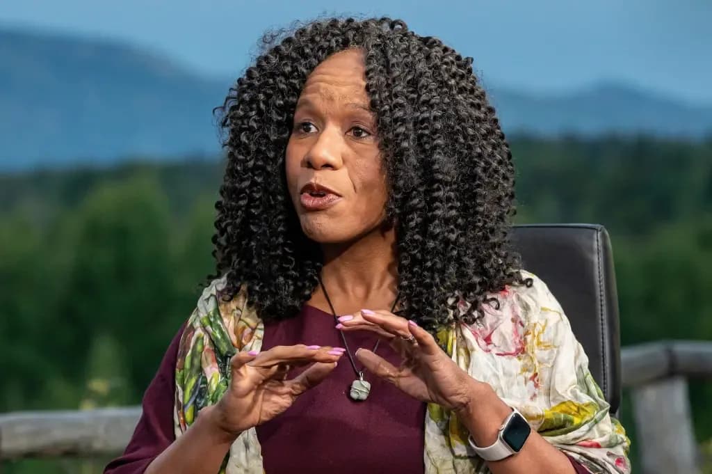 A woman gesturing with her hands while speaking outdoors